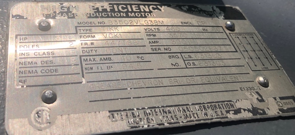 Industrial motor nameplate with specs: high-efficiency 3-phase induction motor, model B3502YLG3BM, 460V, 60Hz, serial/other identifiers visible (weathered plate).