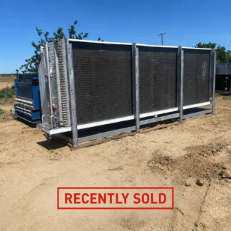 Large industrial radiator/heat-exchanger unit on a dirt lot, with a blue machine nearby and a red 'RECENTLY SOLD' stamp at the bottom.