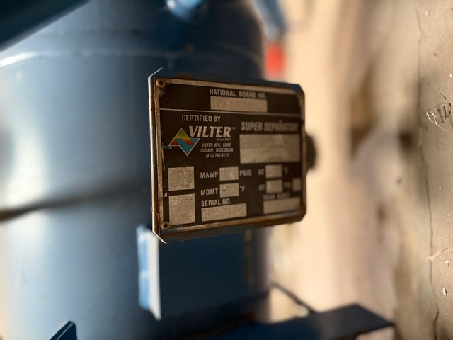 Close-up of a metal nameplate on blue industrial equipment, featuring the VILTER logo and certification details.