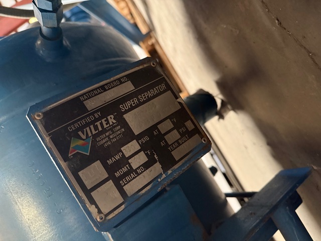 Blue industrial vessel with a metal nameplate reading 'VILTER Super Separator' mounted on its side.