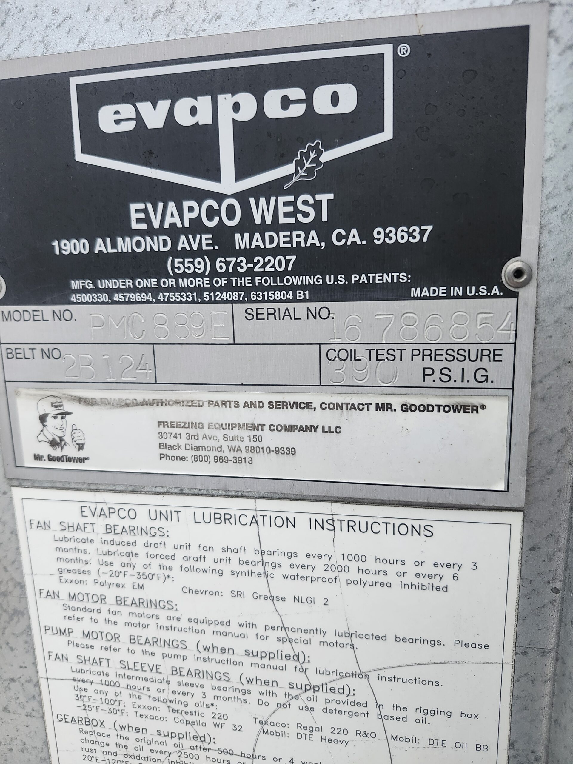 Evapco West company sign showing branding, oak leaf graphic, and contact info (1900 Almond Ave, Madera, CA 93637; (559) 673-2207) with model and serial number panels below.