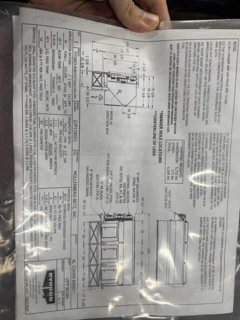 Technical drawing with measurements and notes for a machine enclosure; includes top and side views.