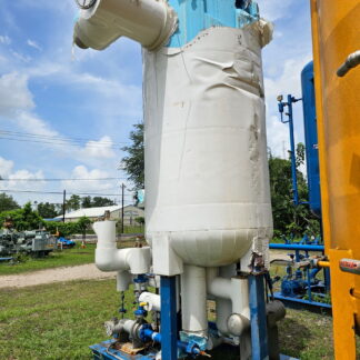 Large white insulated vertical tank on a blue frame with connected piping, outdoors at an industrial site.