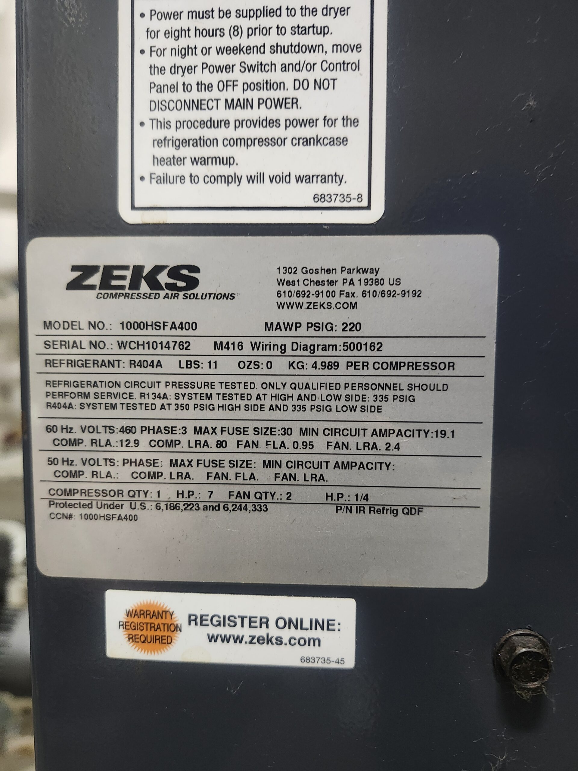 Close-up of a ZEKS label on a dark unit showing model number (1000HSFA400), serial number (WCH1014762), and refrigerant (R404A).